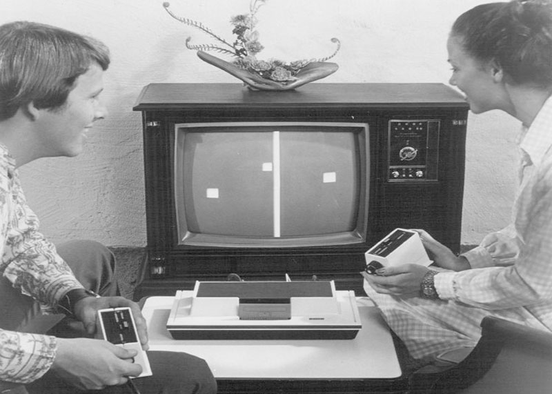 Dos personas frente al televisor jugando con la consola Magnavox Odyssey en los años 70s.